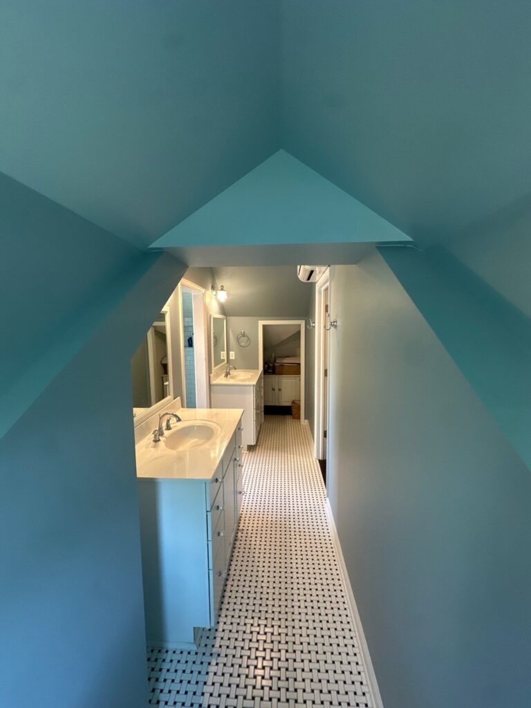 Finished interior painting work by Browning Craftsman Services in a teal-painted attic bathroom