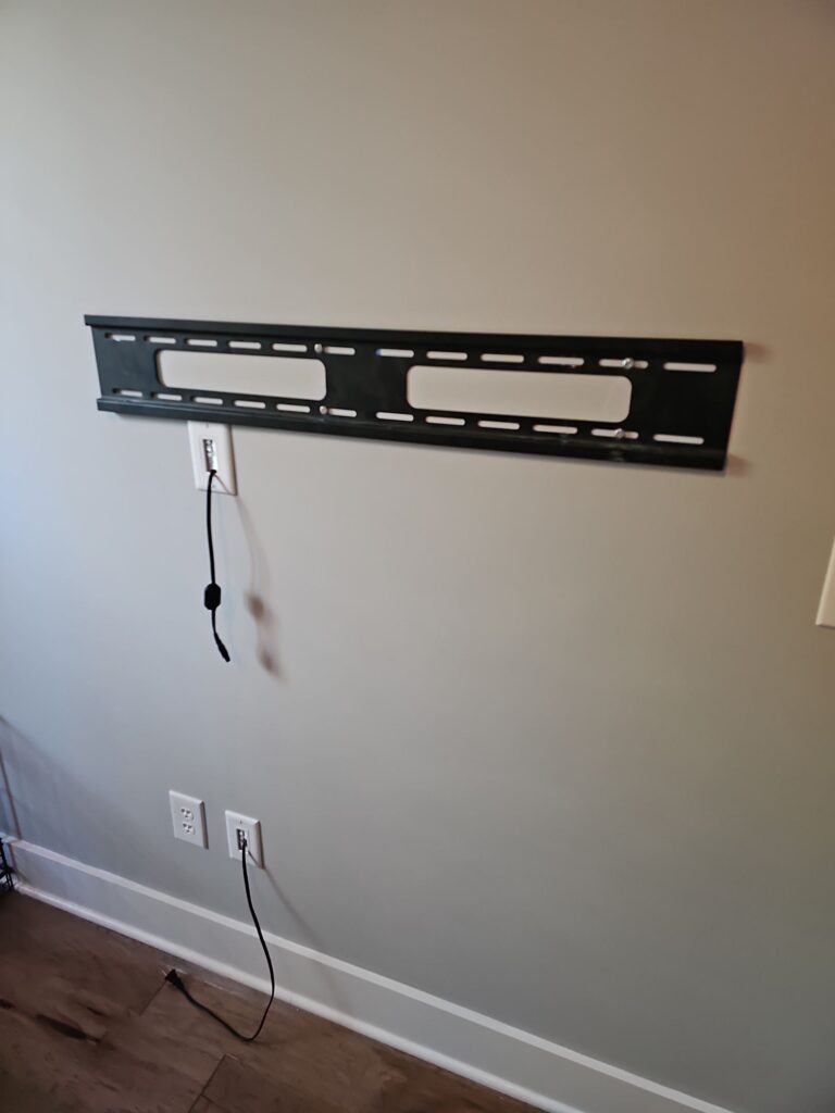 TV wall-mount bracket installed level on the wall by Browning Craftsman Services, with cables tidied